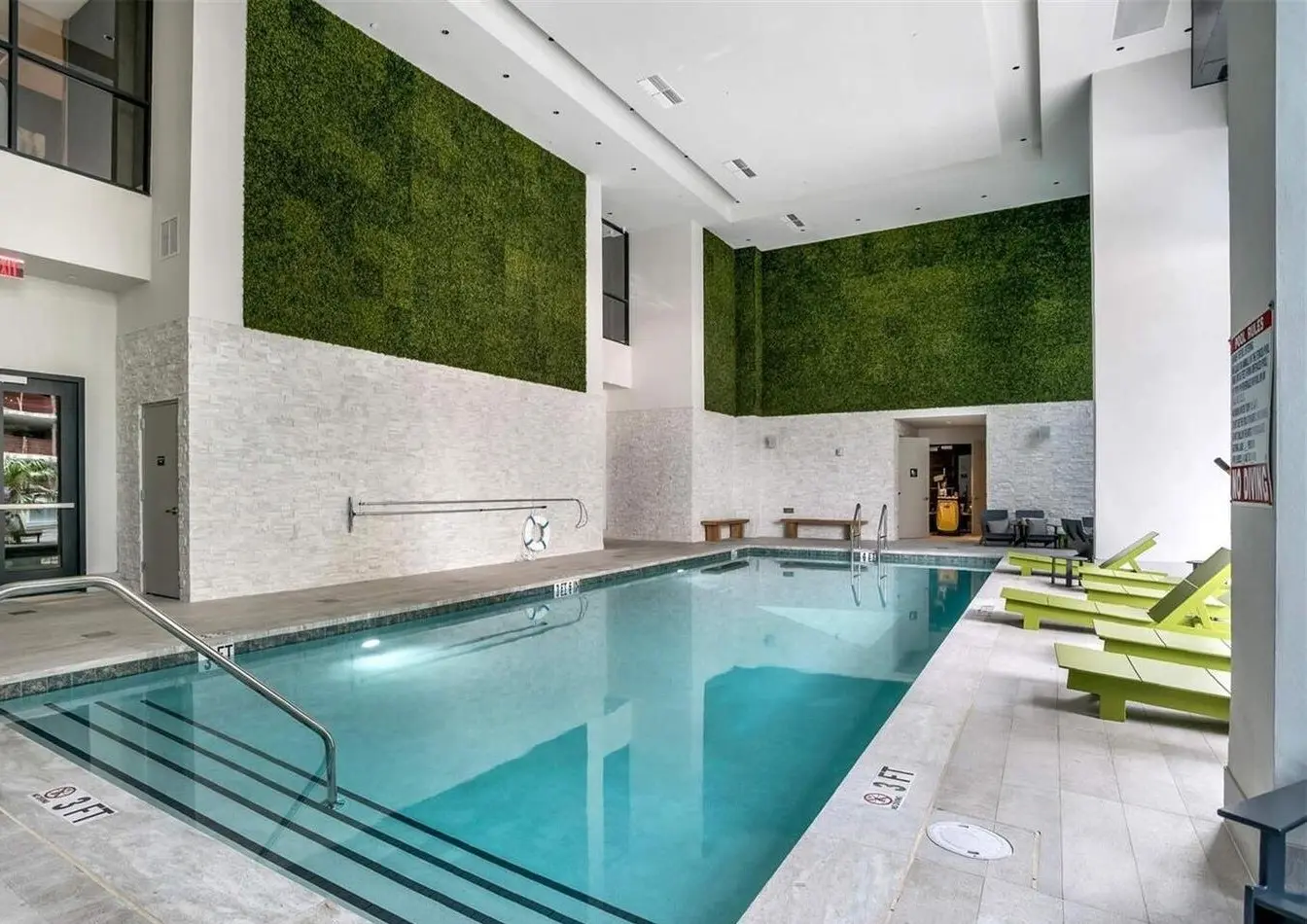 Indoor pool with green walls at 1010 Brickell in Miami.