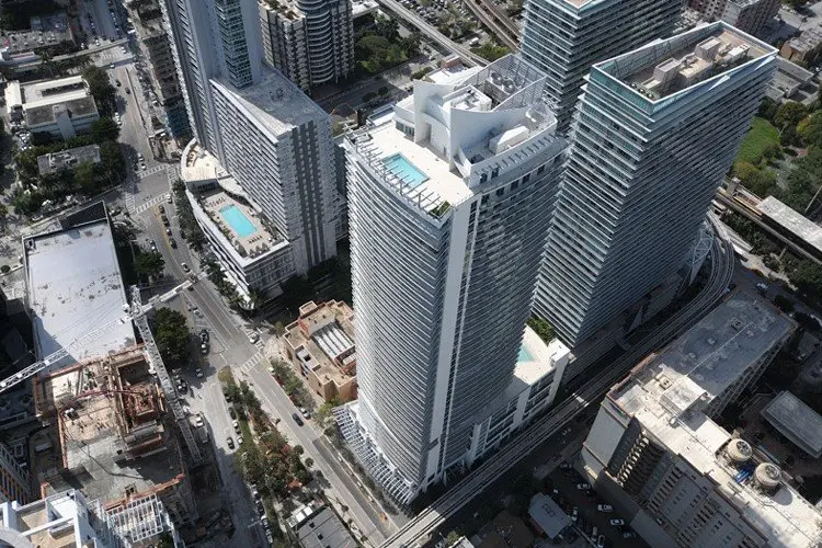 Aerial view of the 1100 Millecento building nestled amidst Miami high-rises.