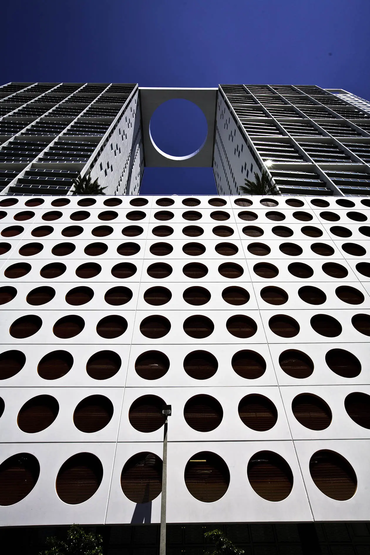 500 Brickell East showcases a modern facade with circular designs set against Miami's skyline.