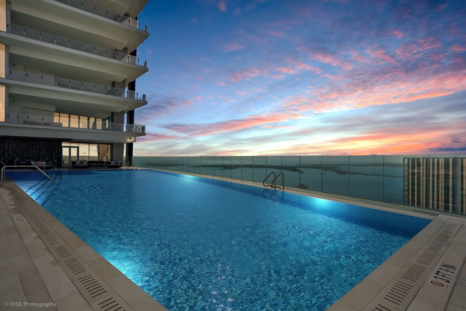 Aston Martin Residences rooftop pool with a sunset view over Miami.