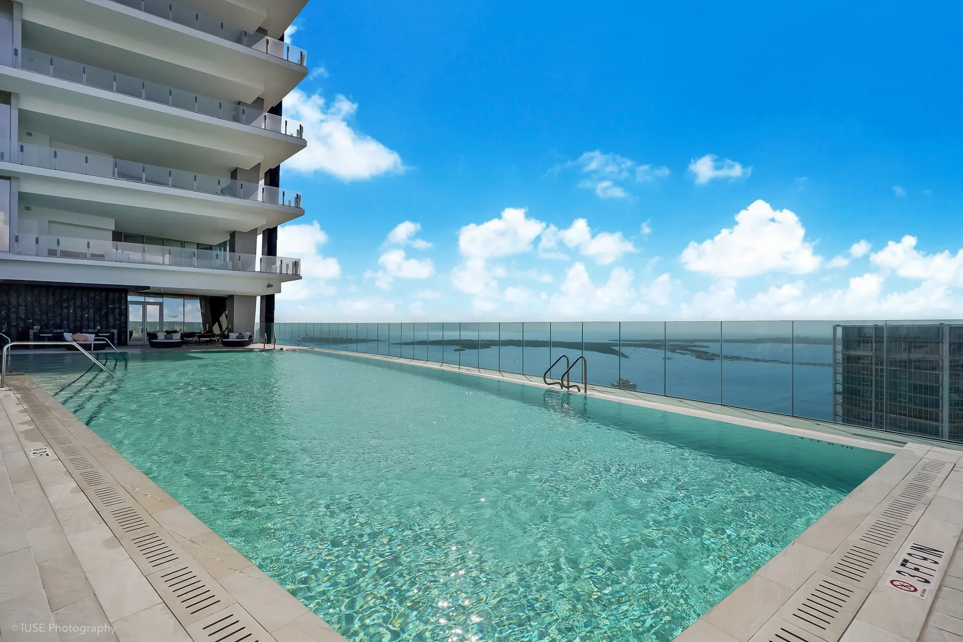 Aston Martin Residences rooftop pool with ocean view.