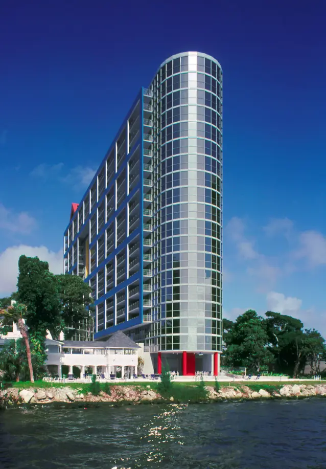 Atlantis on Brickell features a modern curved facade overlooking the water in Miami.
