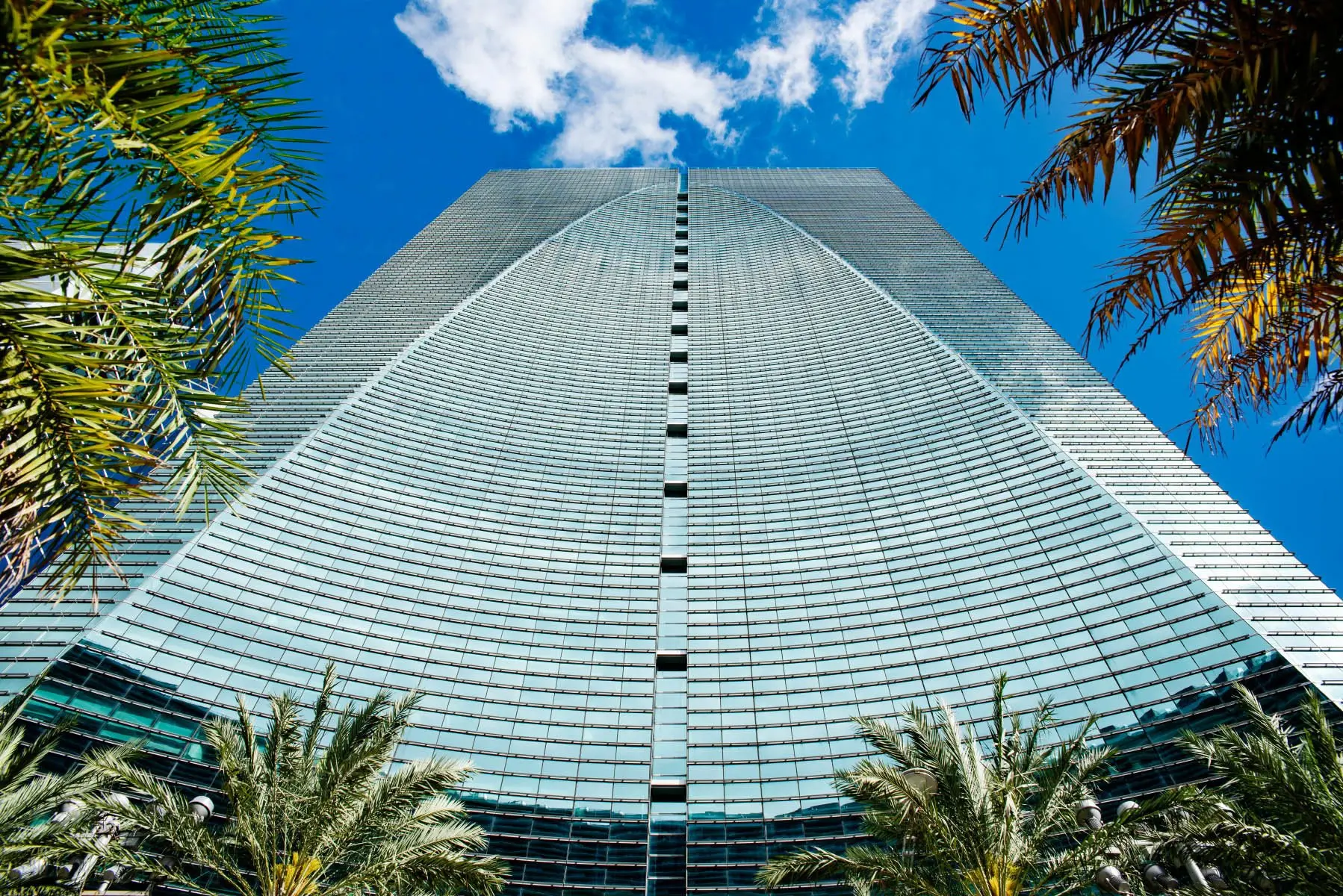 Brickell Arch's glass facade against a clear blue Miami sky.