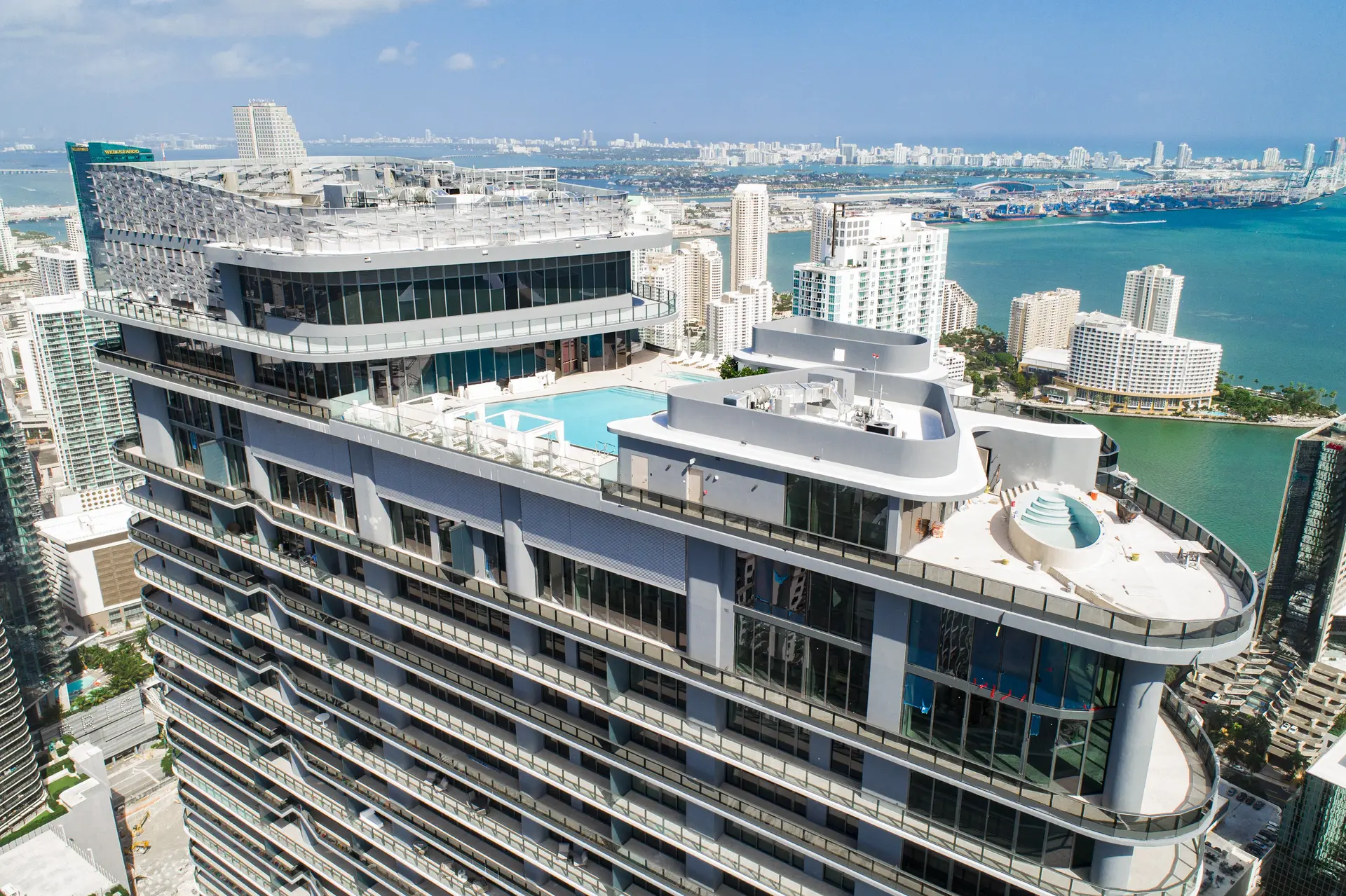 View of Brickell Flatiron's rooftop pool with Miami skyline.