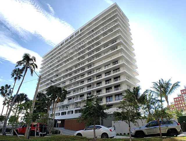 Brickell Harbour modern high-rise with palm trees in Miami.