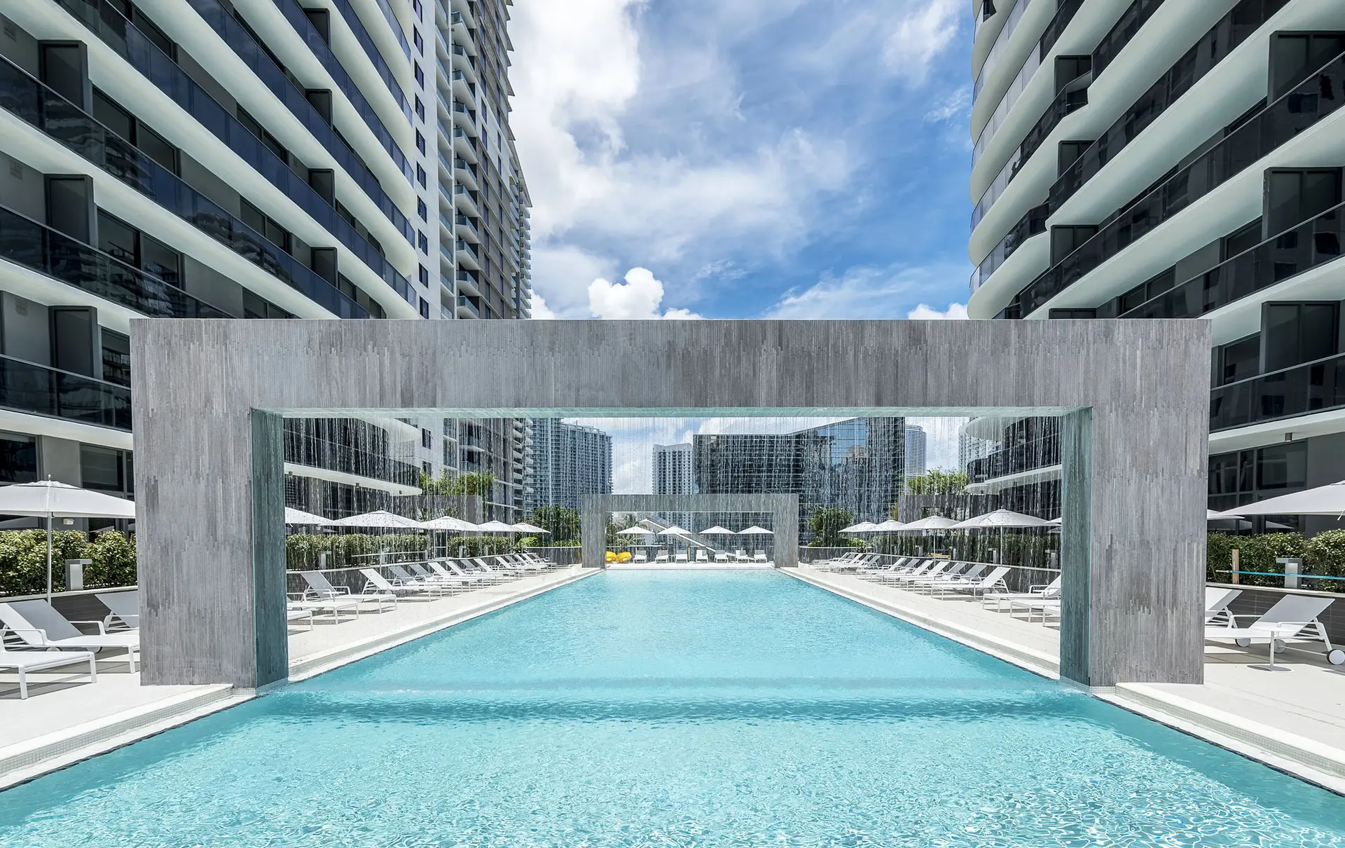 Brickell Heights West pool with waterfall and lounge chairs.