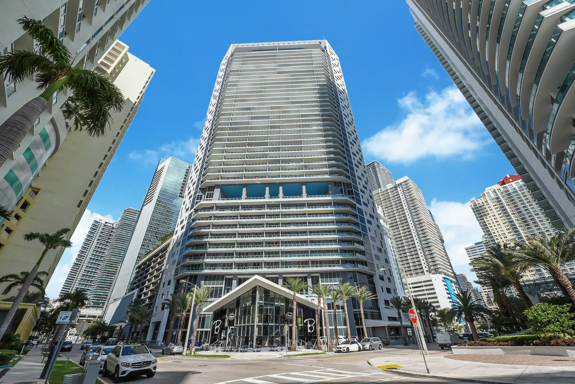 Exterior view of Brickell House in Miami with surrounding modern high-rise buildings.