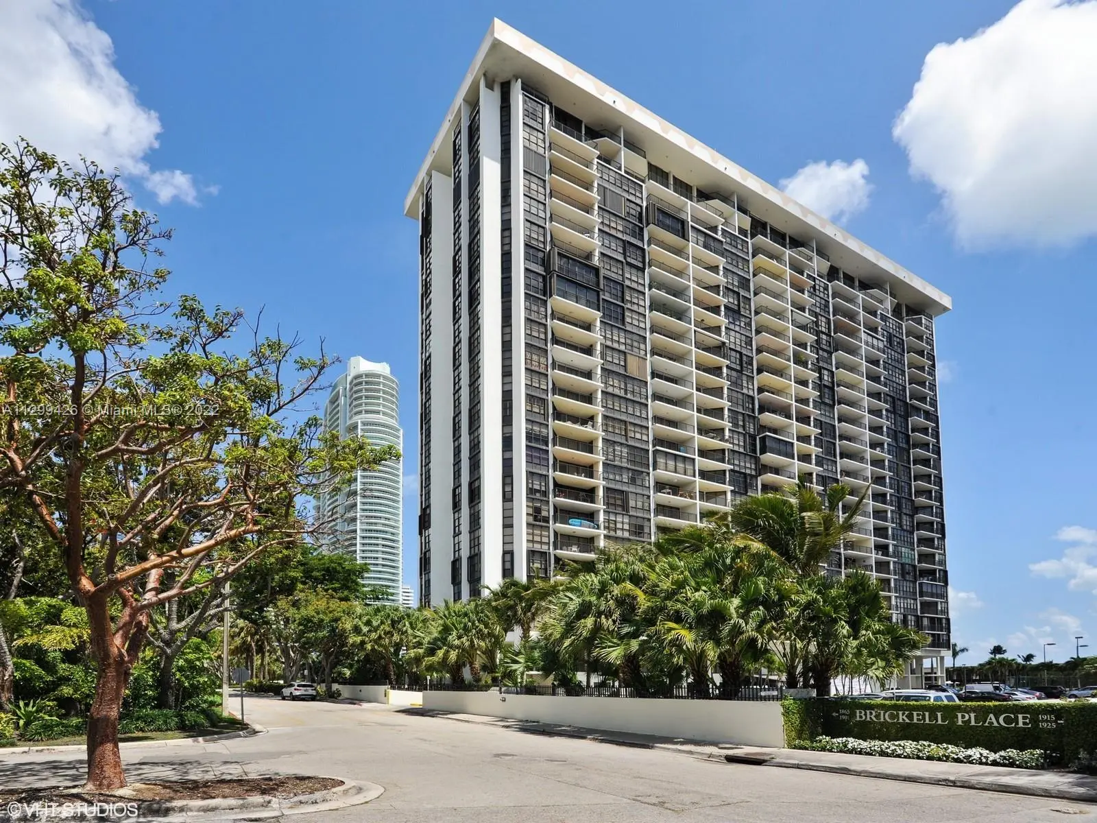 Brickell Place I building exterior with palm trees in Miami.