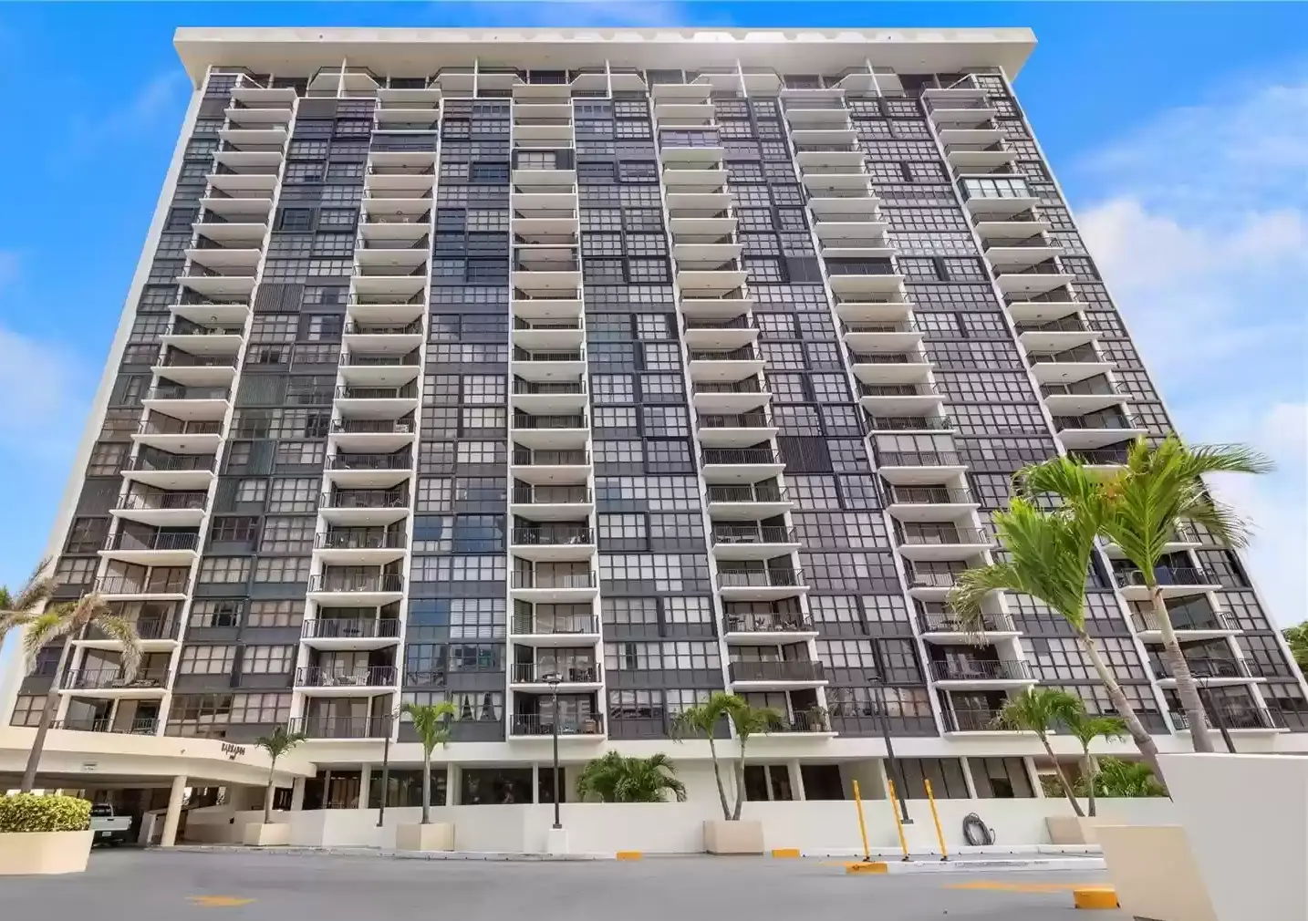 Brickell Place I luxury high-rise with balconies and modern glass facade in Miami.