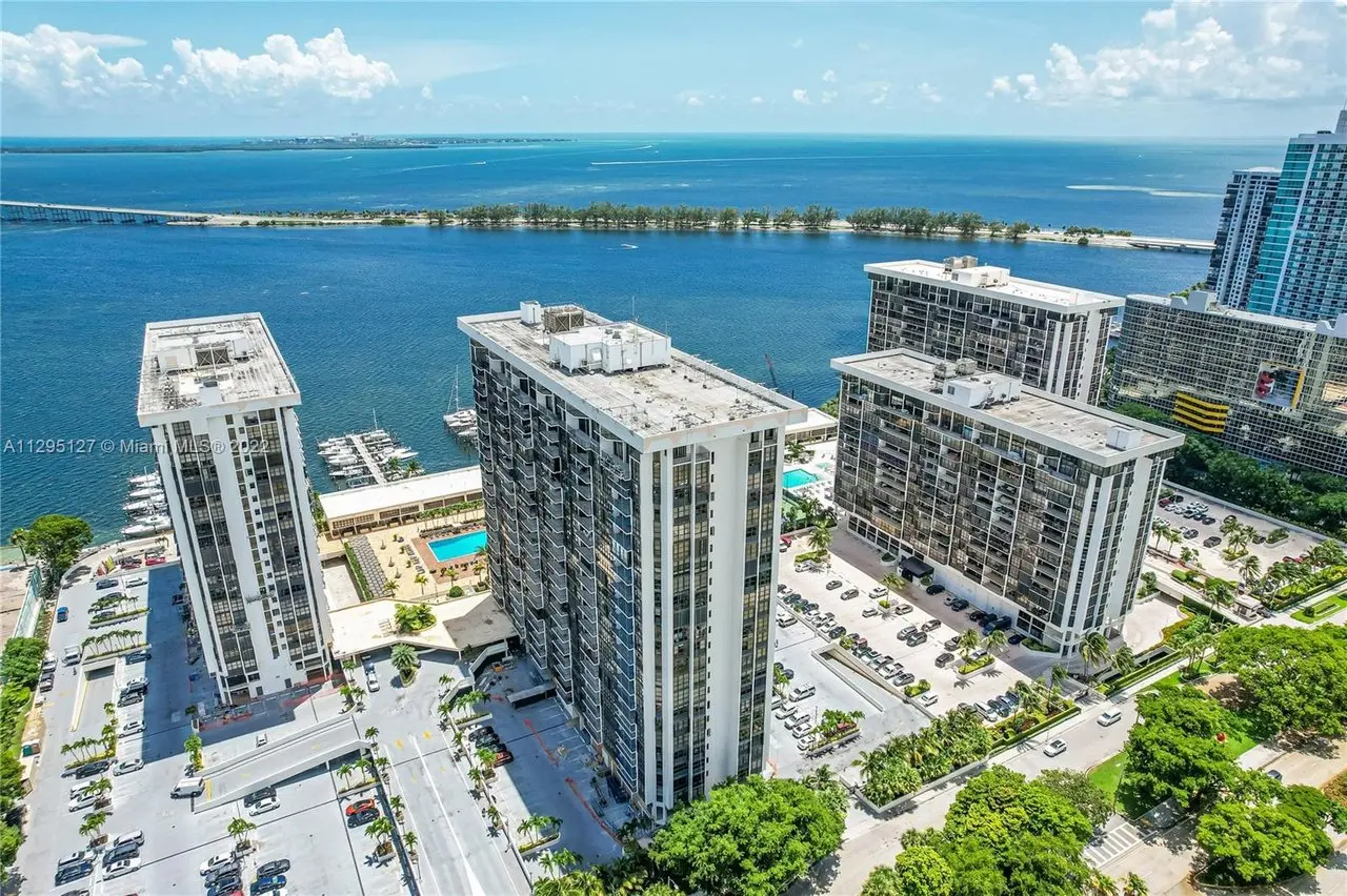Aerial view of Brickell Place I overlooking Miami waterfront and pool area.