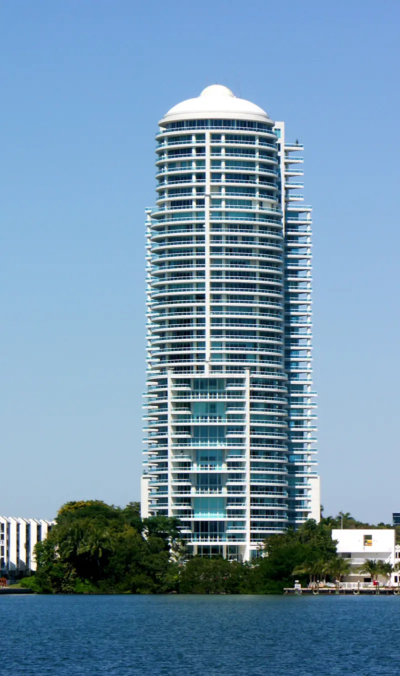 Bristol Tower rises above lush greenery along the Miami waterfront.