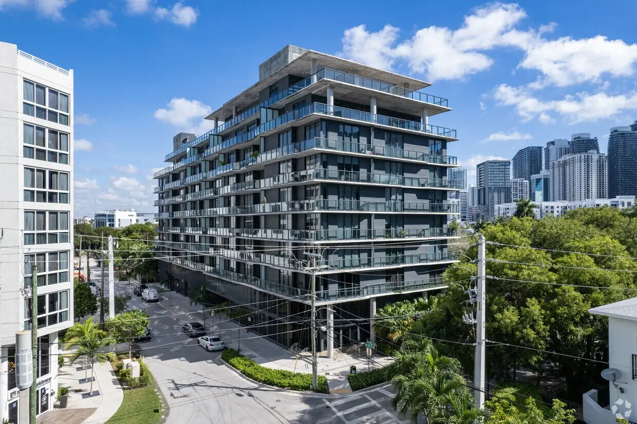 Cassa Brickell modern condo exterior in Miami with cityscape view.