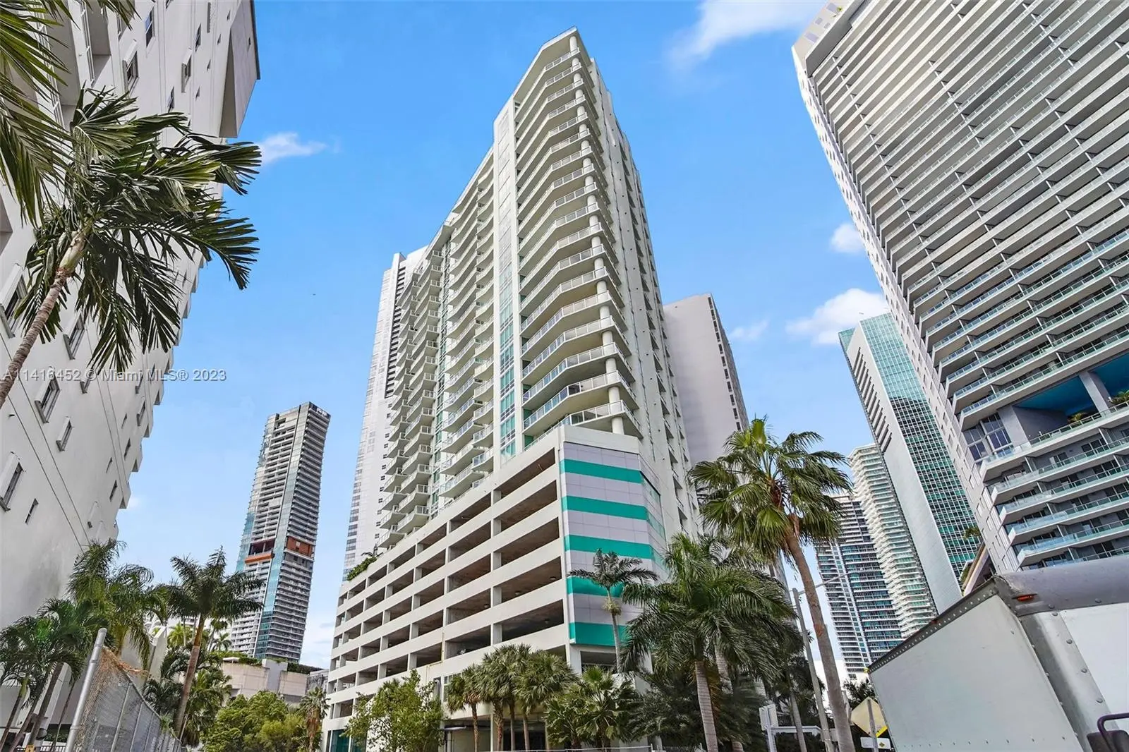 Emerald at Brickell Miami skyscraper with palm trees.