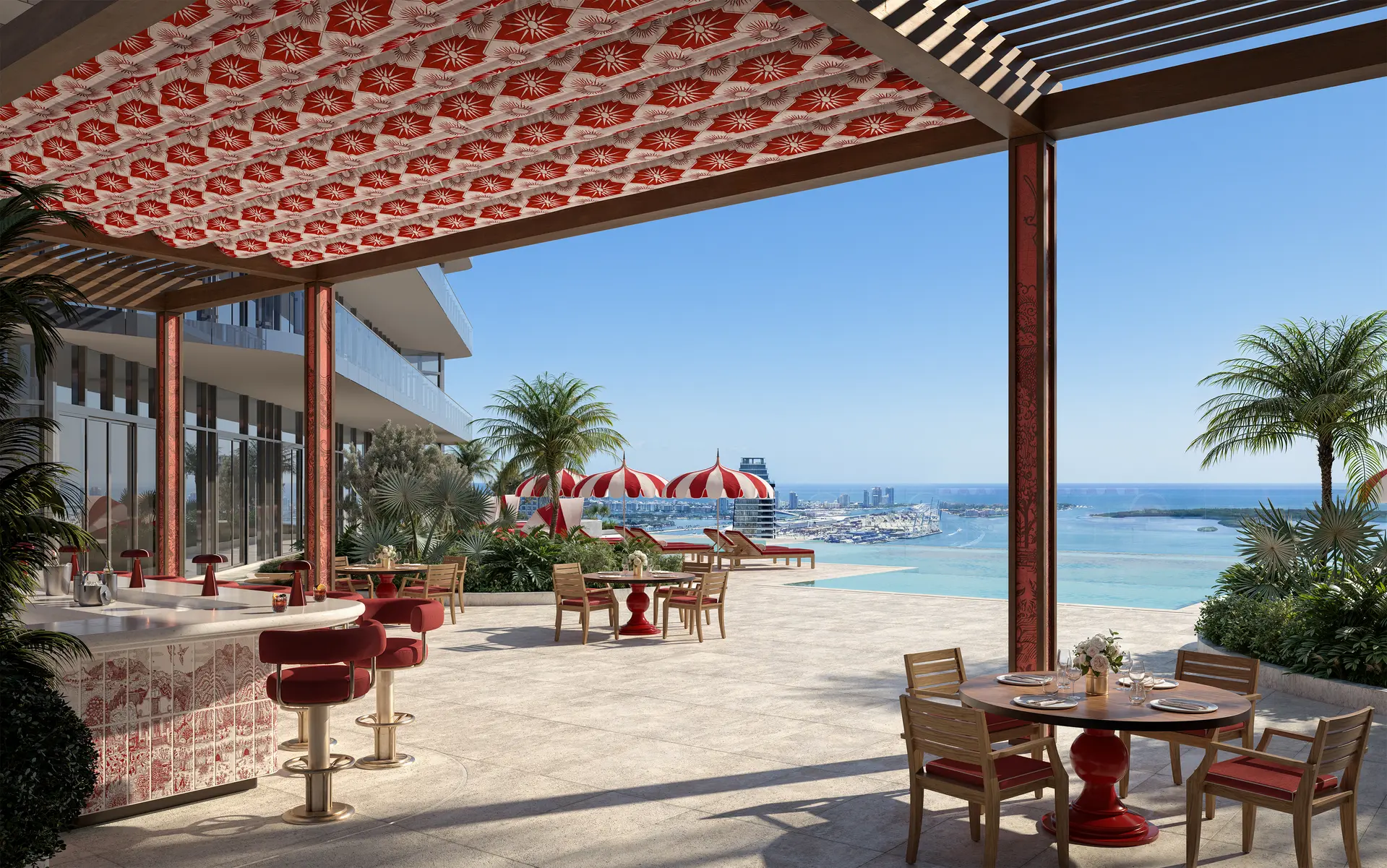 Faena Residences Miami outdoor lounge with ocean view and red decor.
