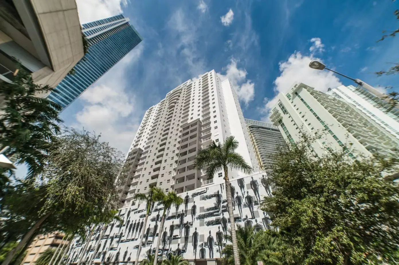 Fortune House building set against a blue sky with surrounding skyscrapers and palm trees.