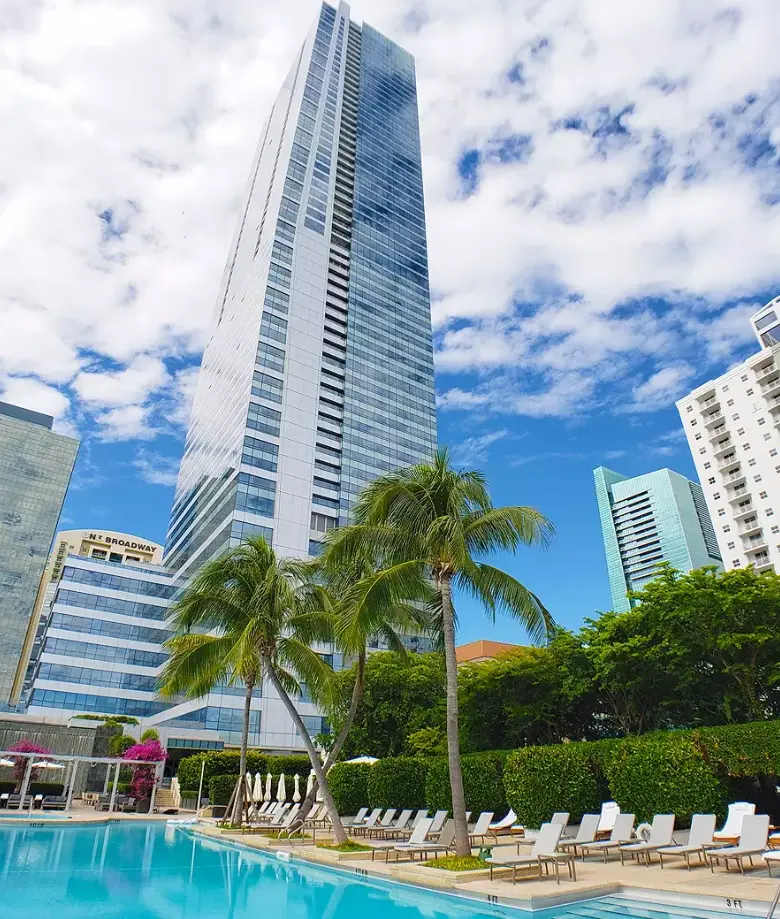 Four Seasons Residences Miami showing the pool area and tall skyscraper.