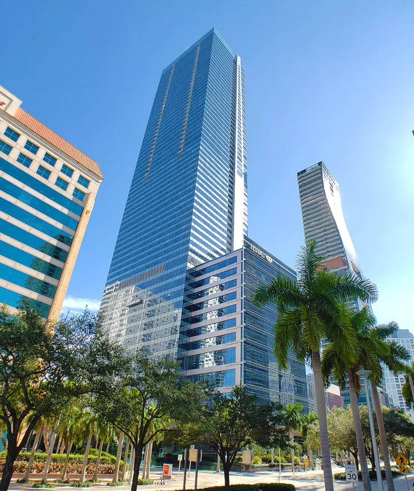 Four Seasons Residences Miami skyscraper with palm trees in the foreground.