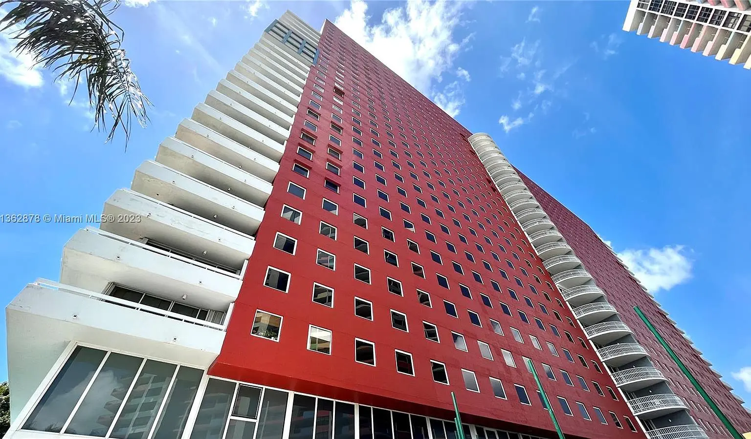 Imperial at Brickell with its bold red facade and geometric windows against a blue sky.