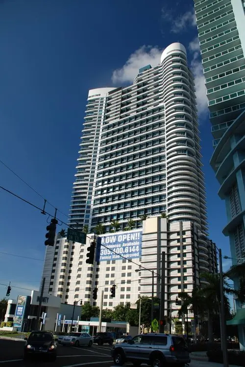 Infinity at Brickell high-rise building with blue skies in Miami.