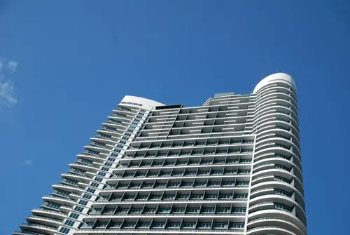 Infinity at Brickell high-rise against a clear blue sky.