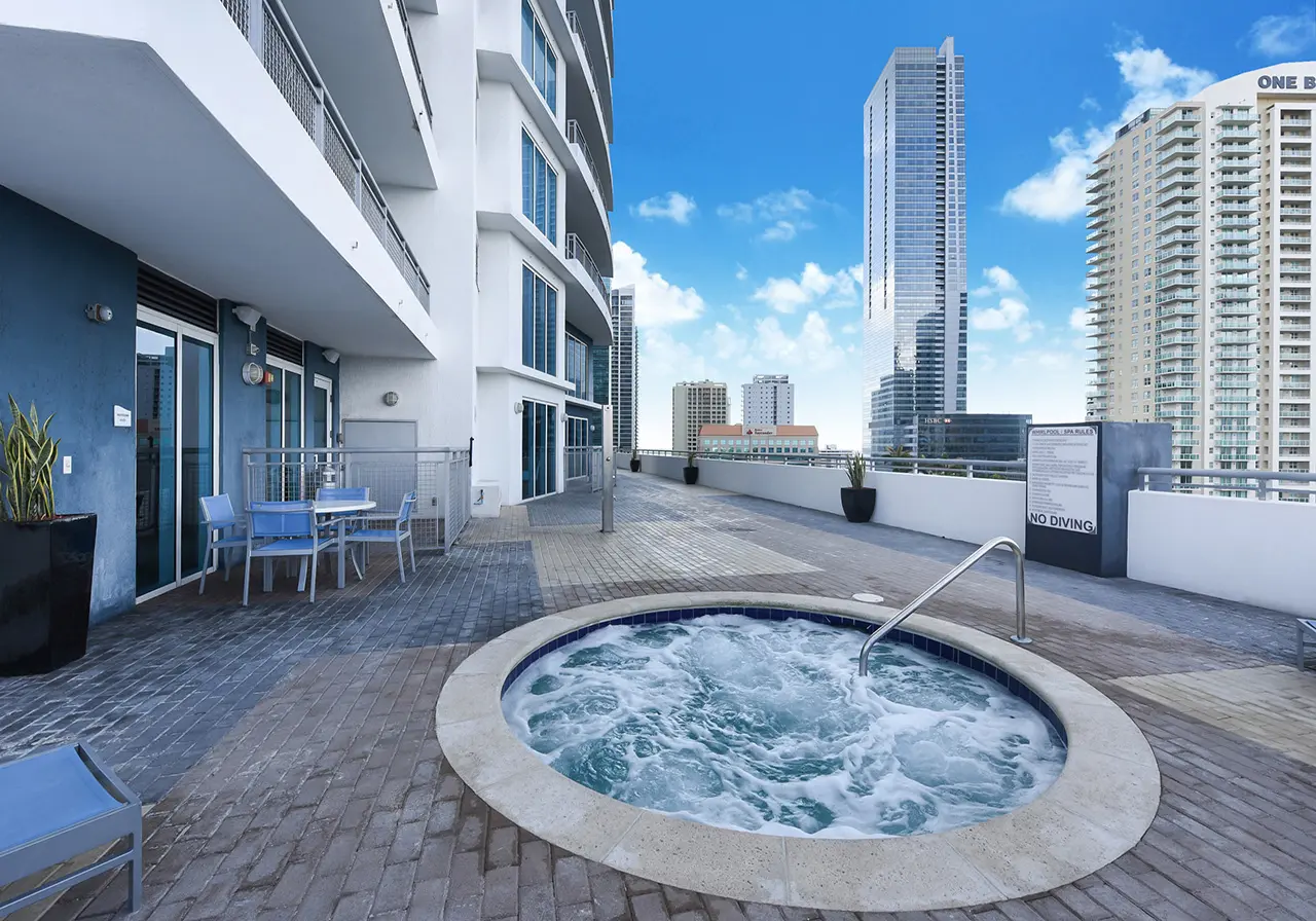 Infinity at Brickell rooftop terrace with jacuzzi overlooking Miami skyline.