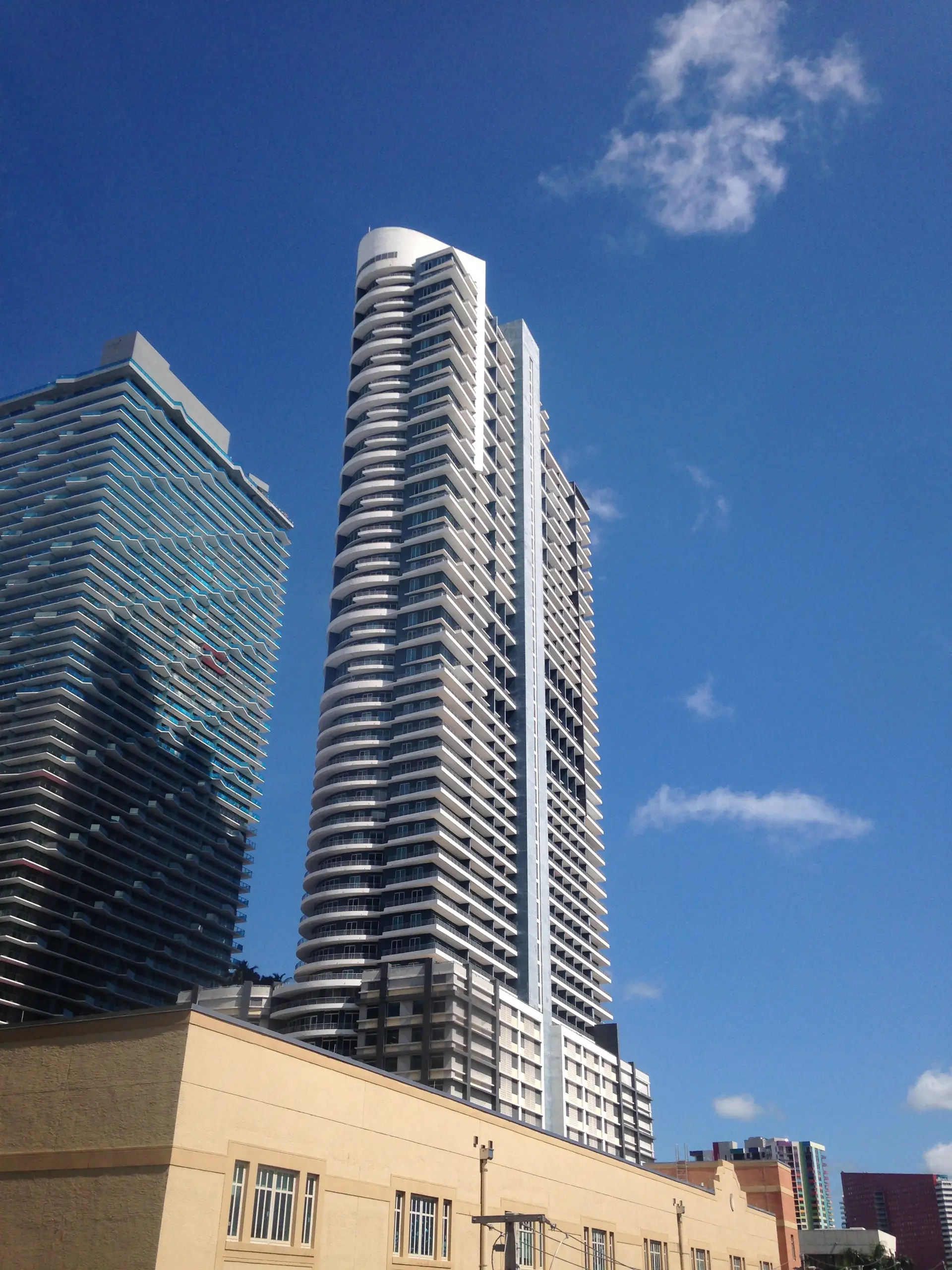 Infinity at Brickell tower with clear blue Miami sky.
