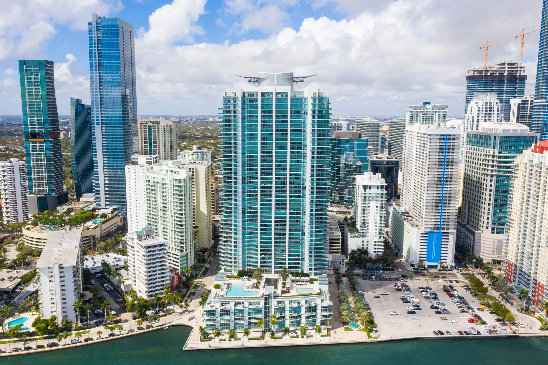 Aerial view of Jade at Brickell Bay surrounded by downtown Miami skyline.