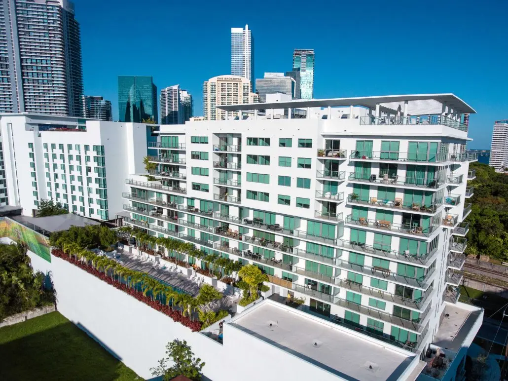 Le Parc at Brickell white building with terrace and Miami skyline.