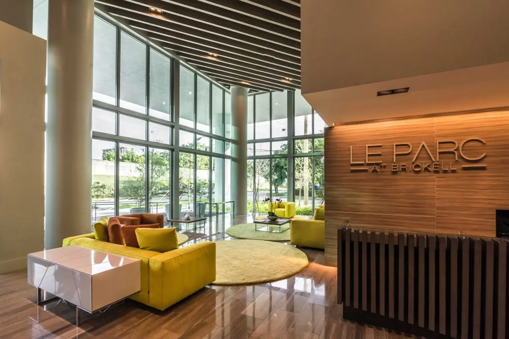 Modern lobby interior of Le Parc at Brickell with large windows and vibrant seating.
