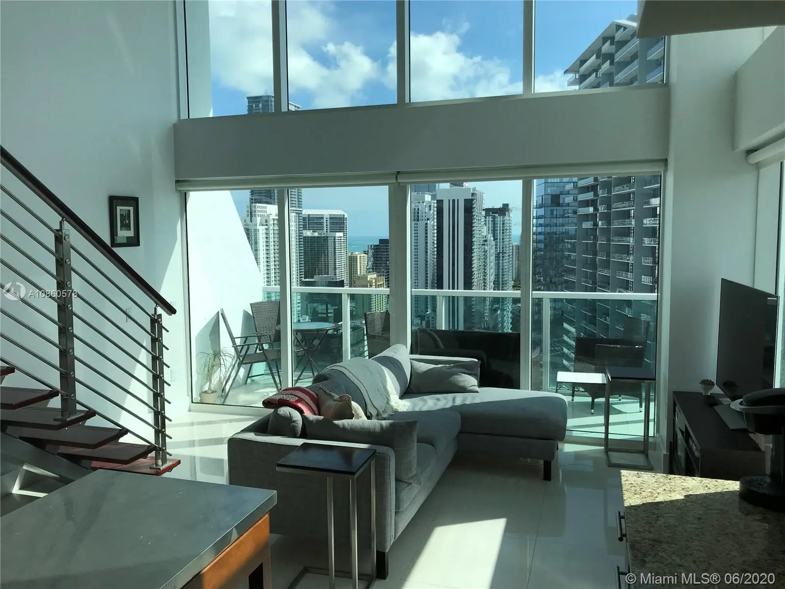 Modern living room with city view at Lofts on Brickell Two in Miami.