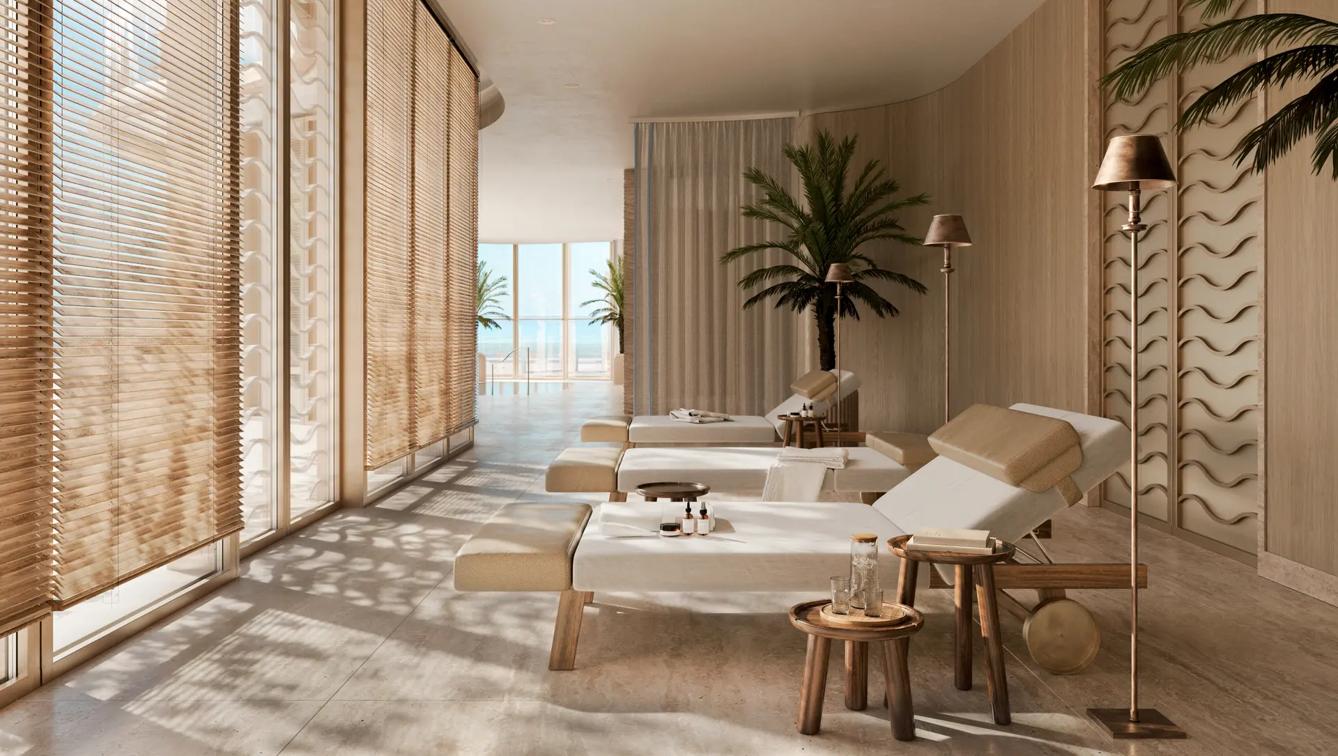 Miami Lux Seaside lounge area with multiple sunbeds, elegant decor, and floor-to-ceiling windows.