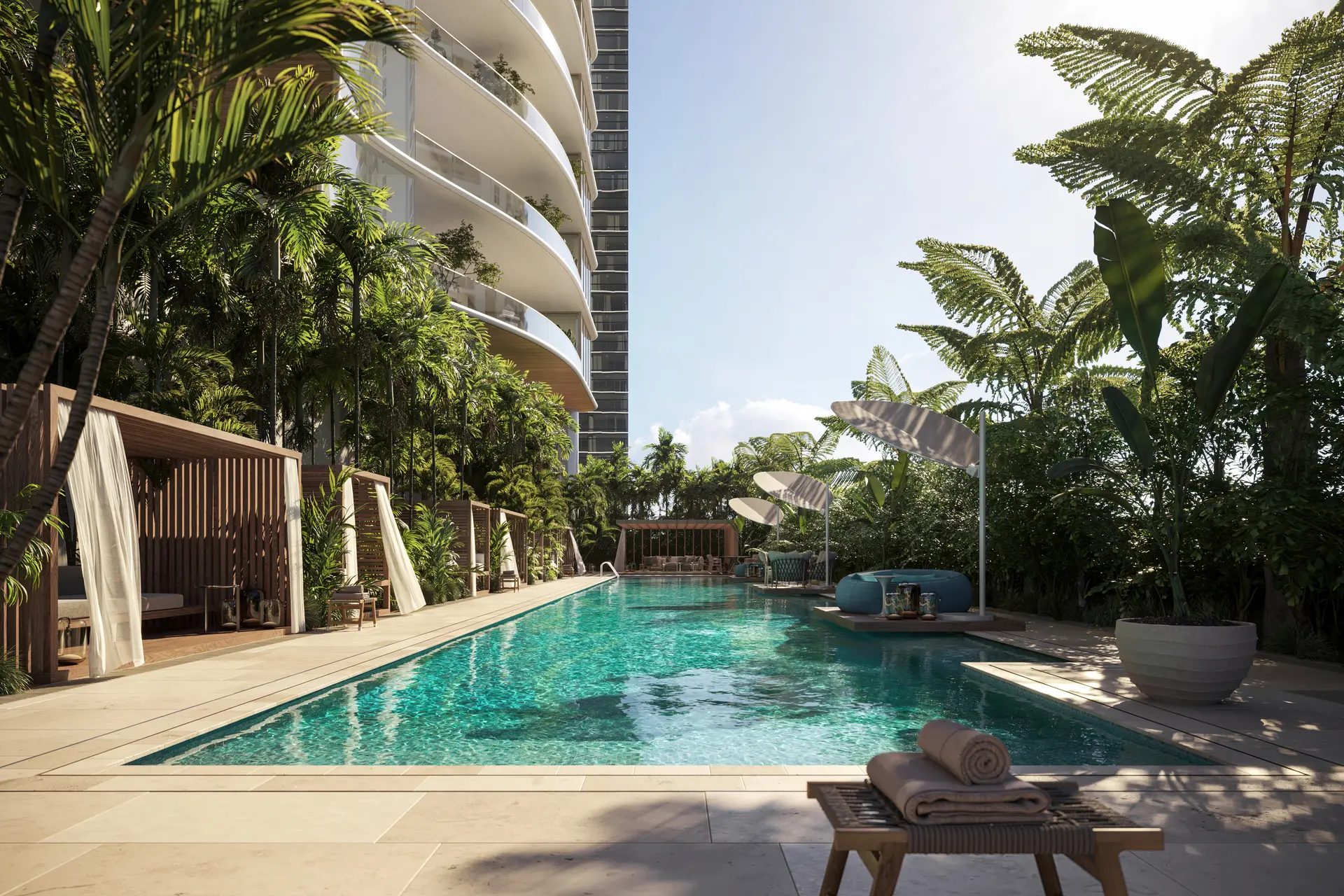 Miami Luxury Project pool with cabanas and lush greenery surrounding it