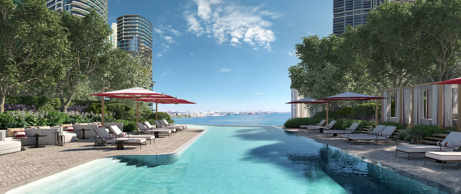 Luxurious poolside area at Miami luxury development featuring palm trees and modern architecture.
