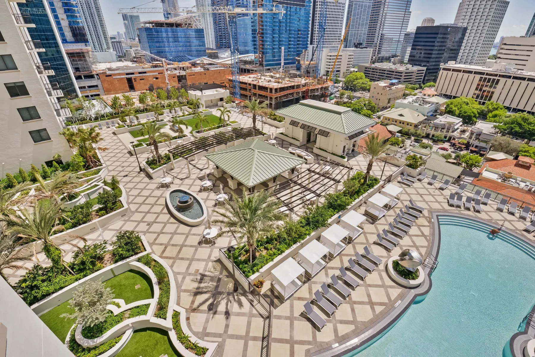 Aerial view of Nine at Mary Brickell Village showcasing a rooftop pool area with lounge seating.