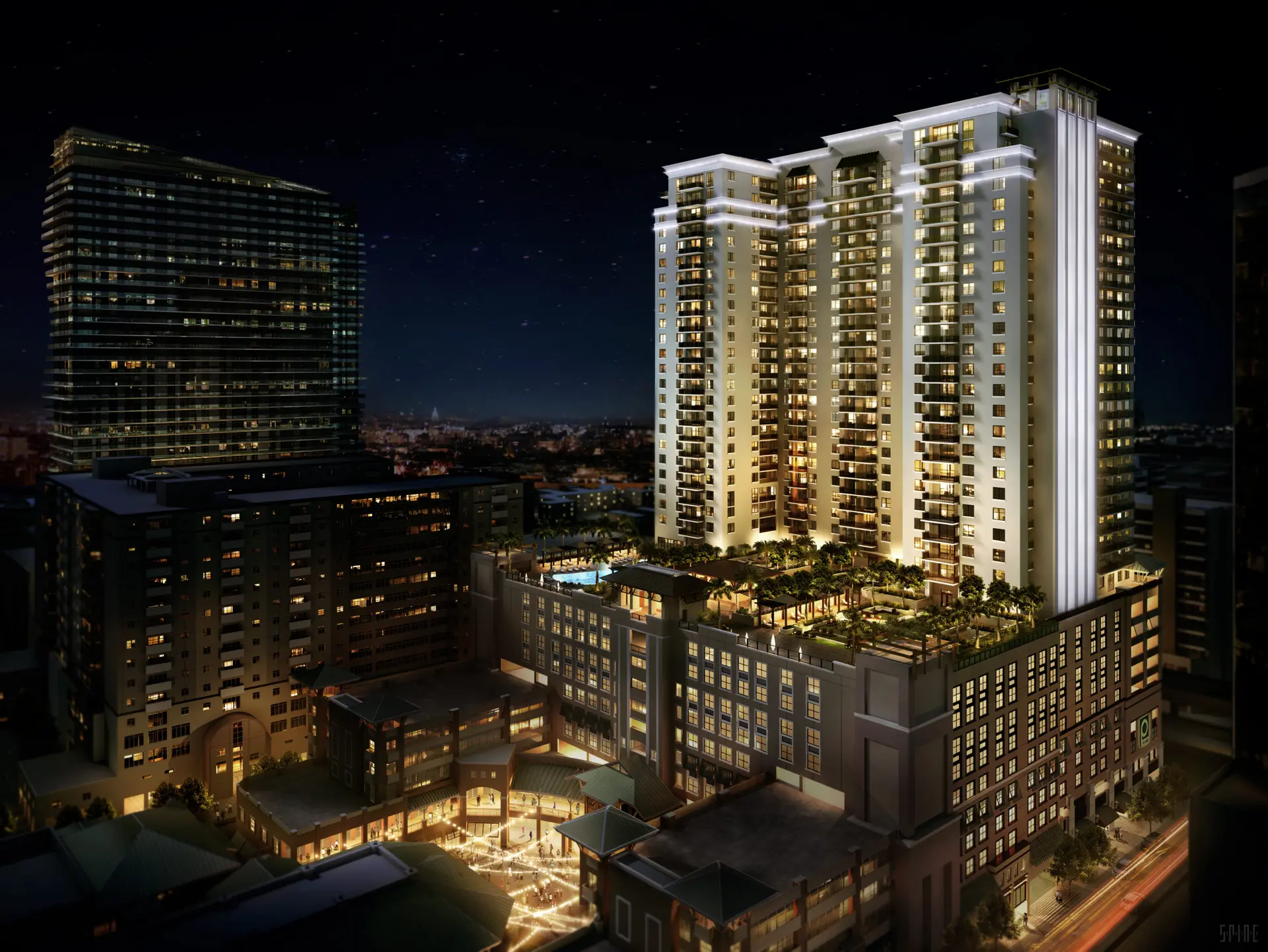 Nighttime view of Nine at Mary Brickell Village with illuminated towers.