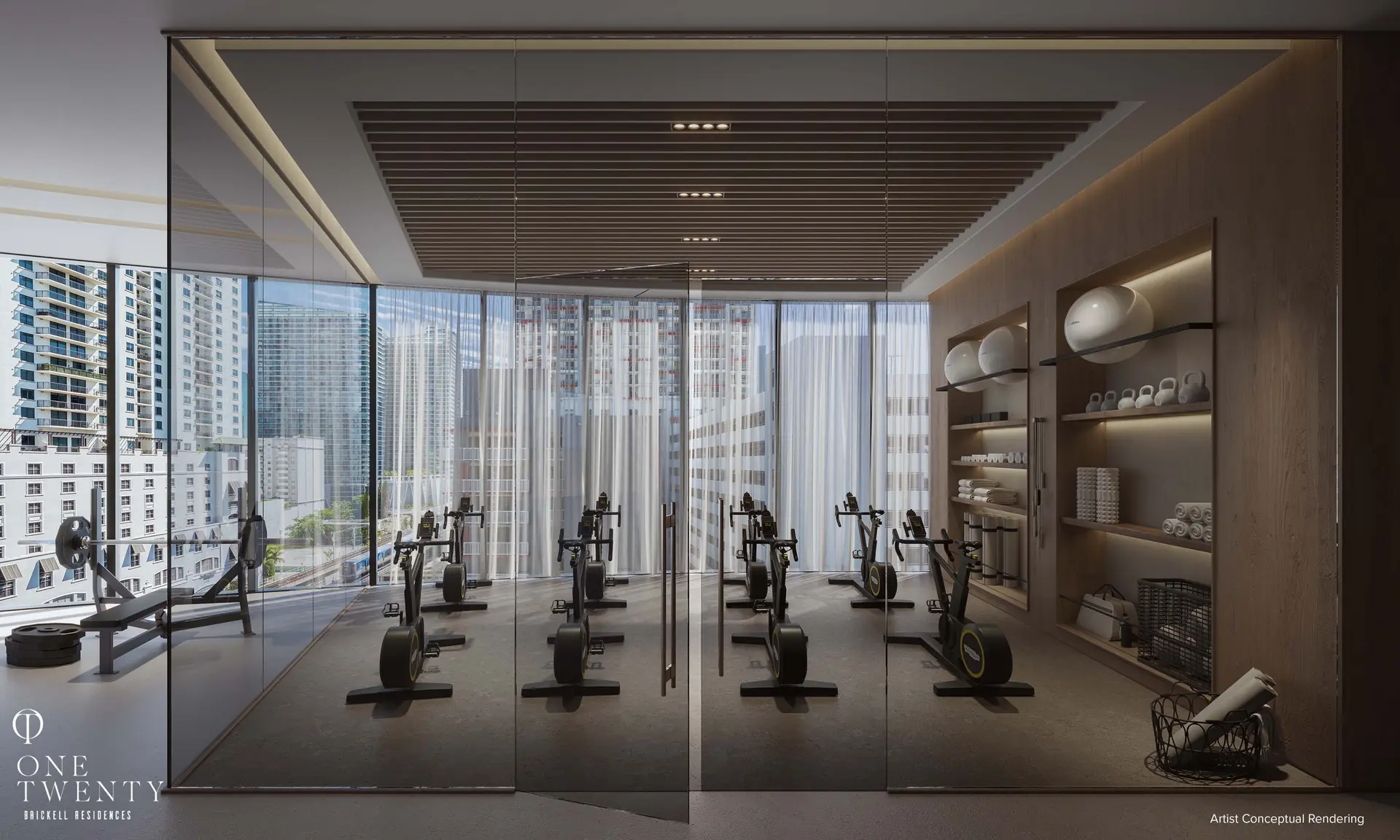One Twenty Residences features a sleek fitness room with modern equipment and cityscape views.