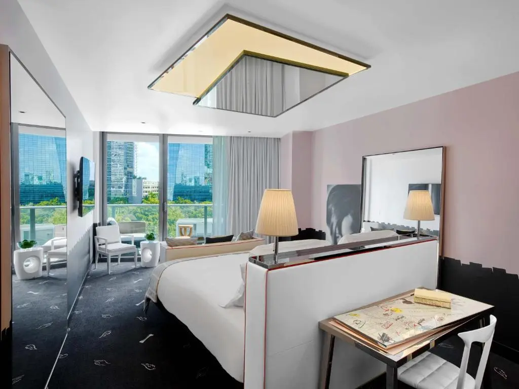 Elegant bedroom interior in SLS Brickell with city skyline view.