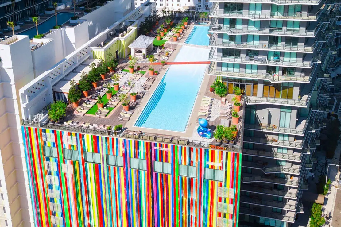 SLS Brickell features a rooftop pool deck with vibrant wall art.