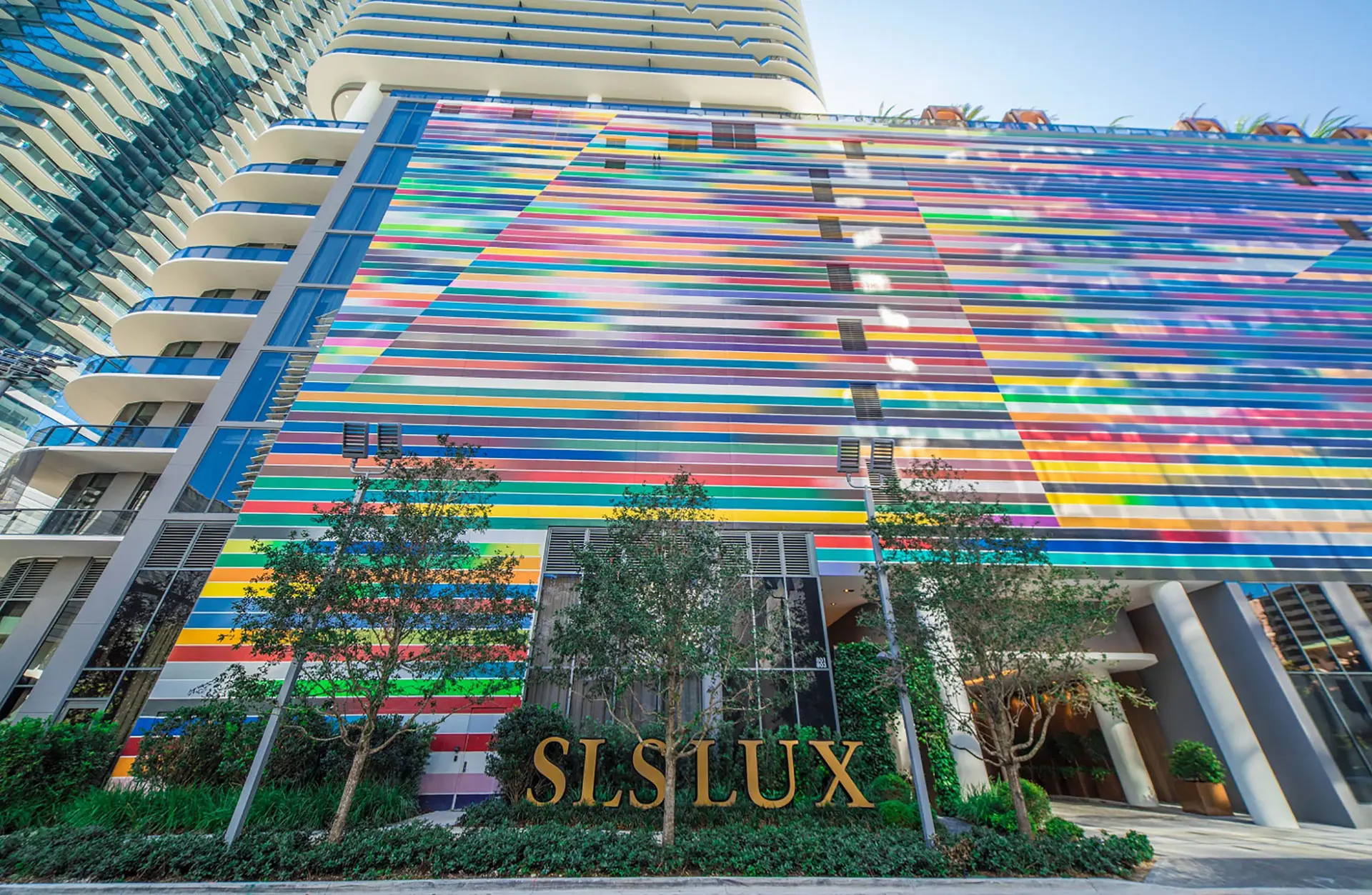 SLS Lux building facade with vibrant stripes in Miami.