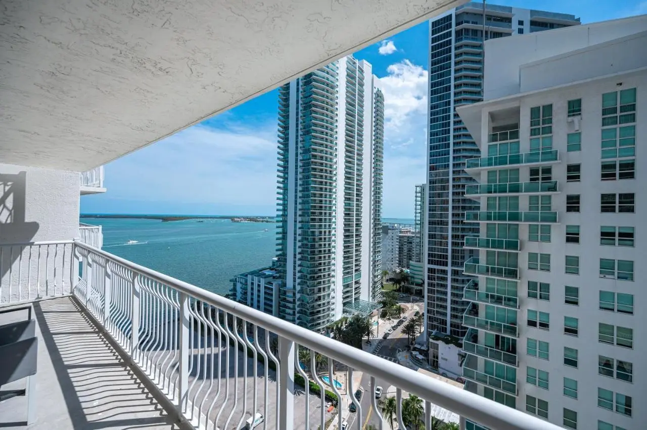 The Club at Brickell Bay balcony view overlooking skyscrapers and Biscayne Bay.