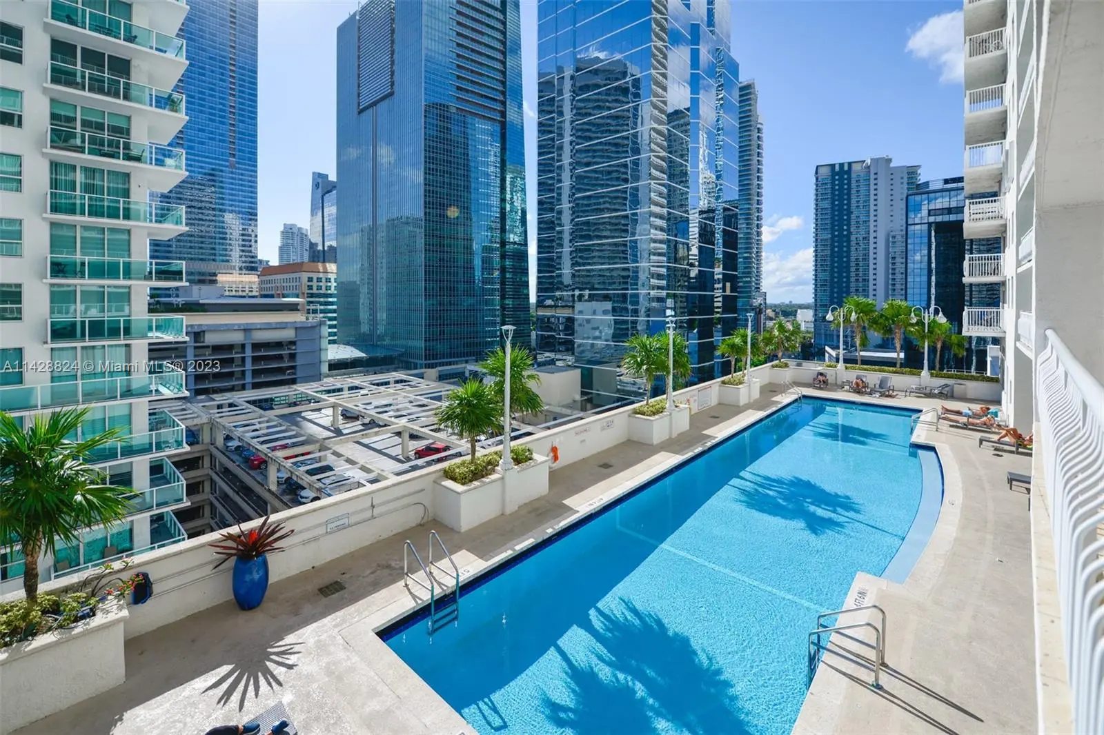 The Club at Brickell Bay's rooftop pool with city skyline in Miami.