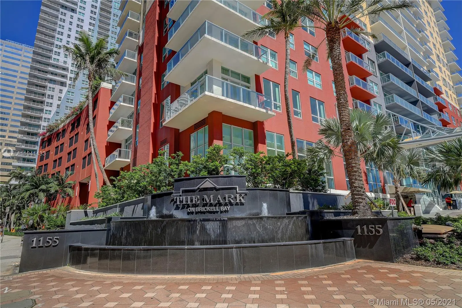 Exterior view of The Mark on Brickell with fountain and palm trees.