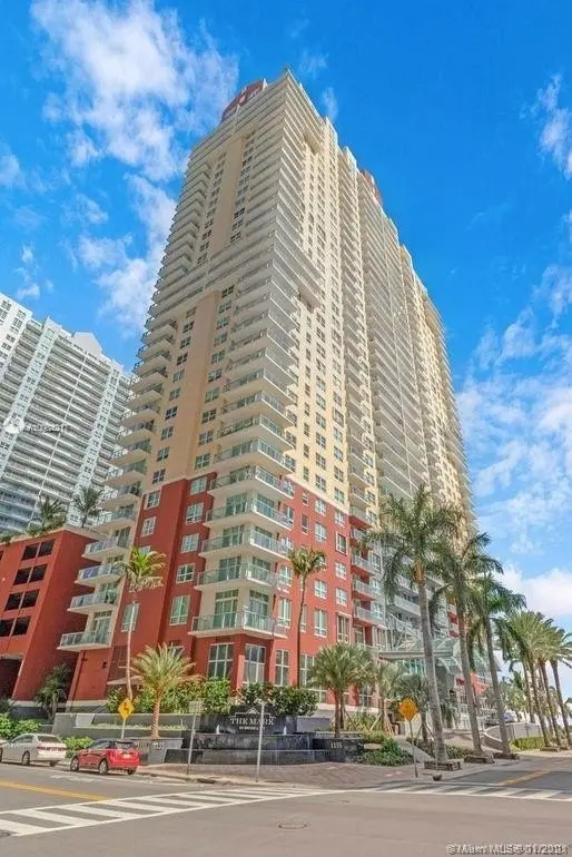 Street-level view of The Mark on Brickell showing its towering architecture.