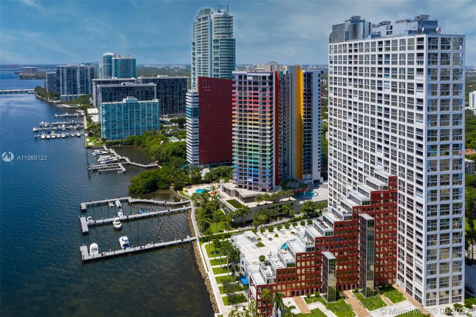 Skyline view of The Palace featuring colorful high-rise buildings and marina in Miami.