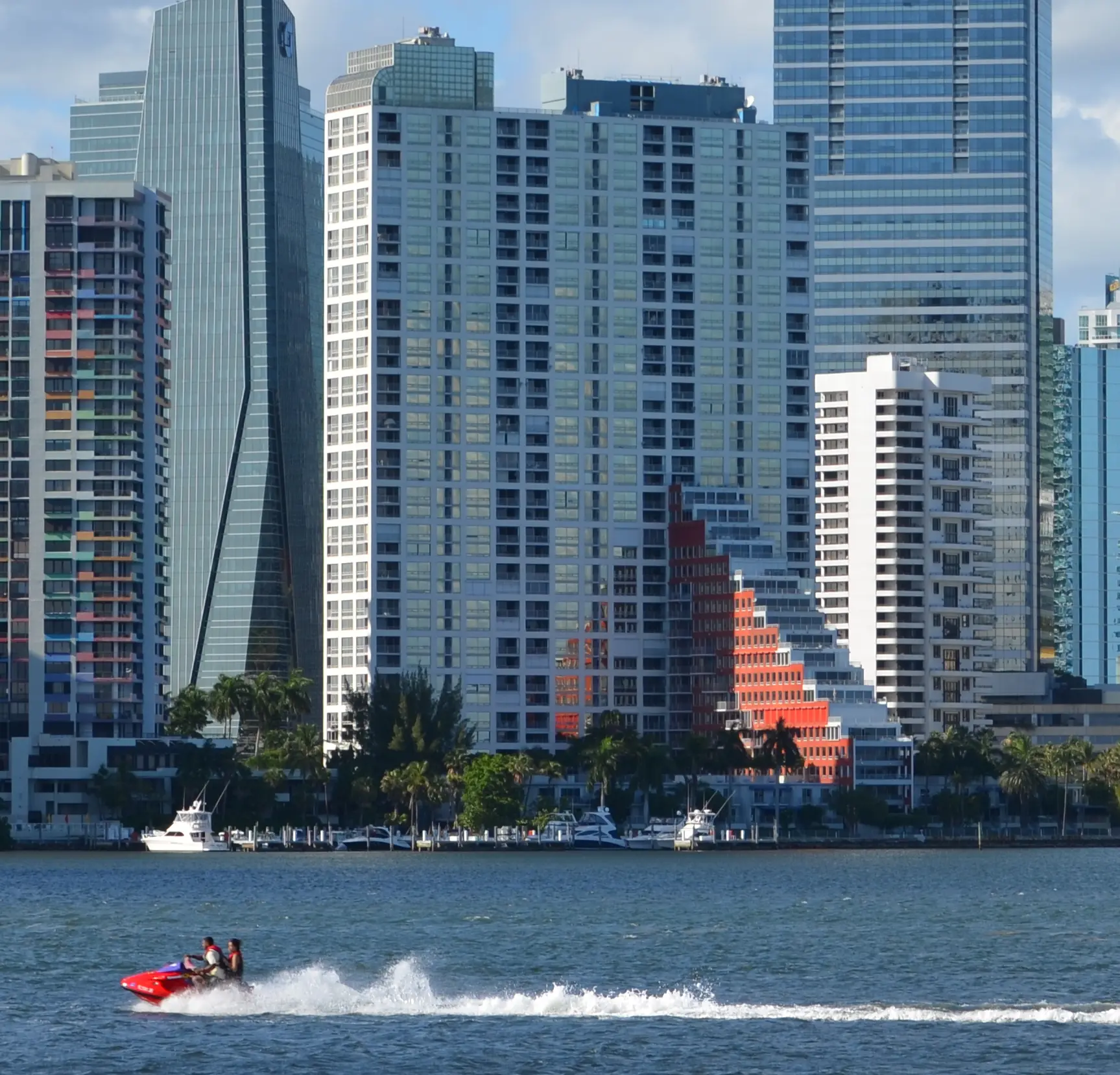 The Palace in Miami with a waterfront view and surrounding skyscrapers.