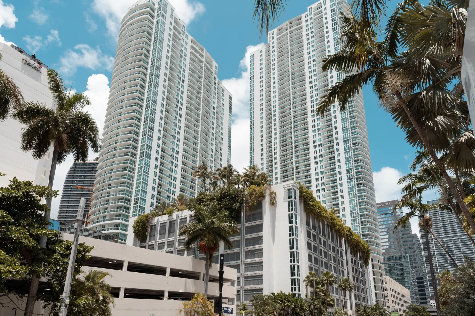 The Plaza on Brickell East showing high-rise towers and lush greenery.