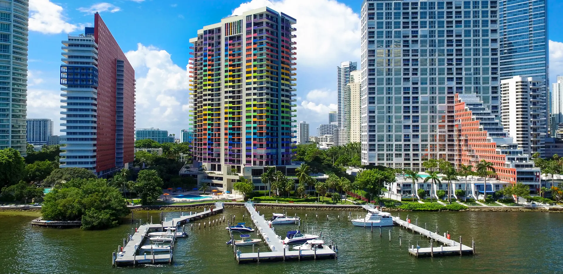 Villa Regina colorful skyscraper with marina on Miami waterfront.