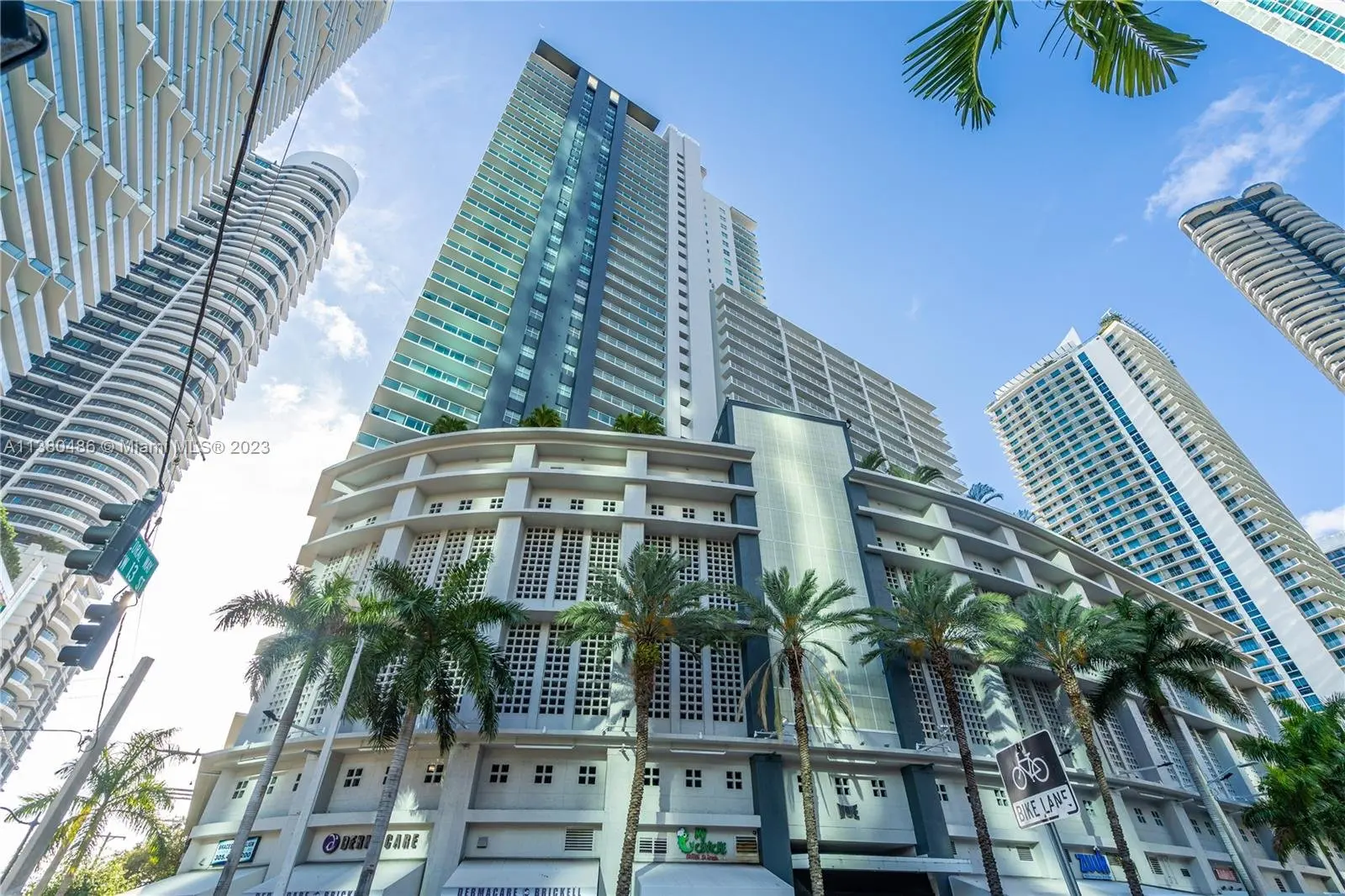 Vue at Brickell modern high-rise building in Miami with palm trees.